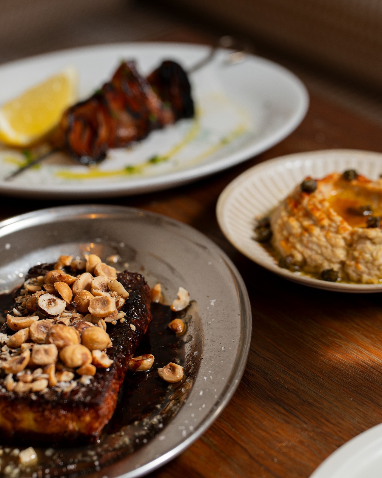 White bean dip with fried capers and sharing plates at Elvina